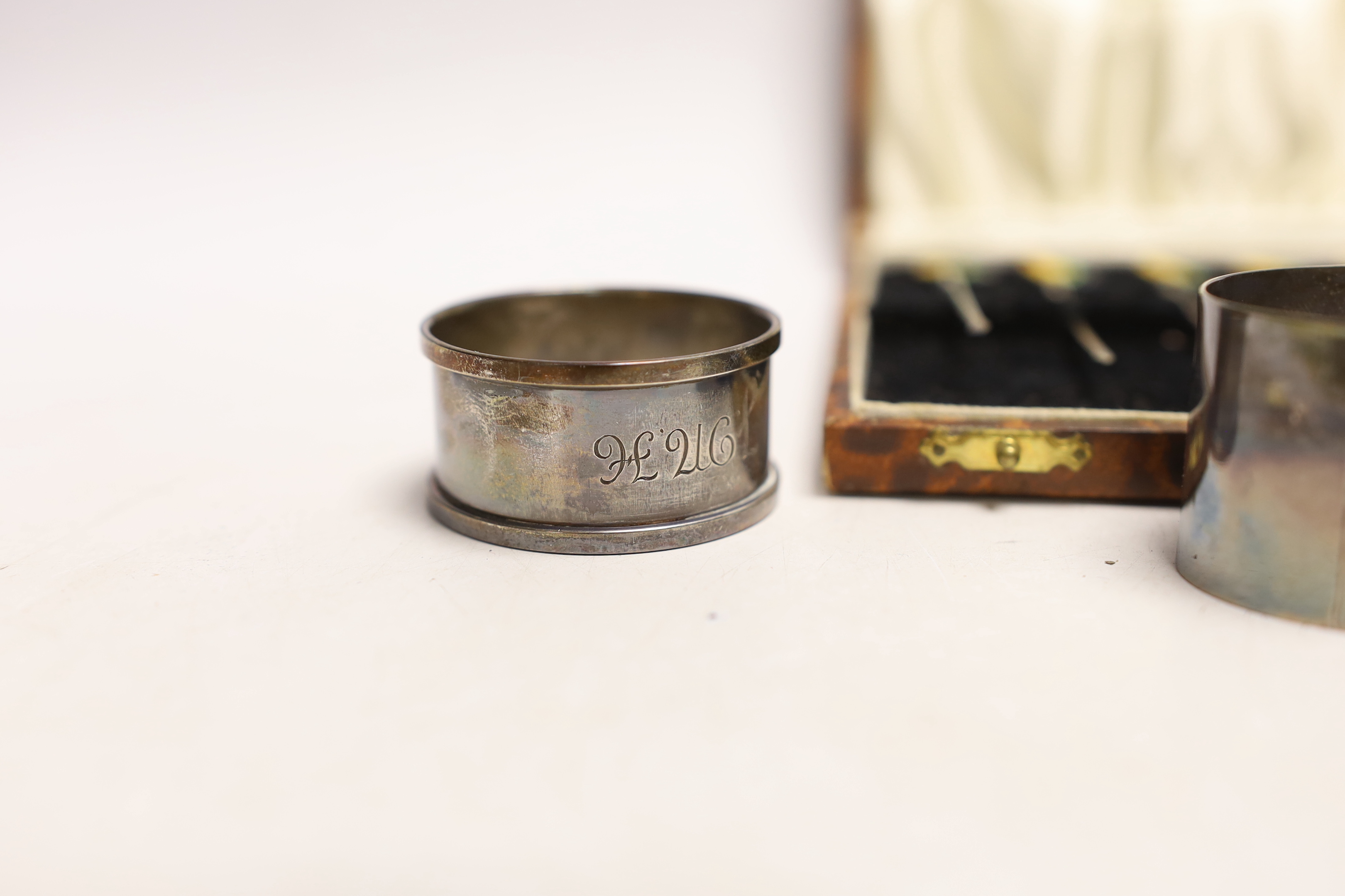 A cased set of six sterling and enamel cocktail sticks, with cockerel terminals and three silver napkin rings.